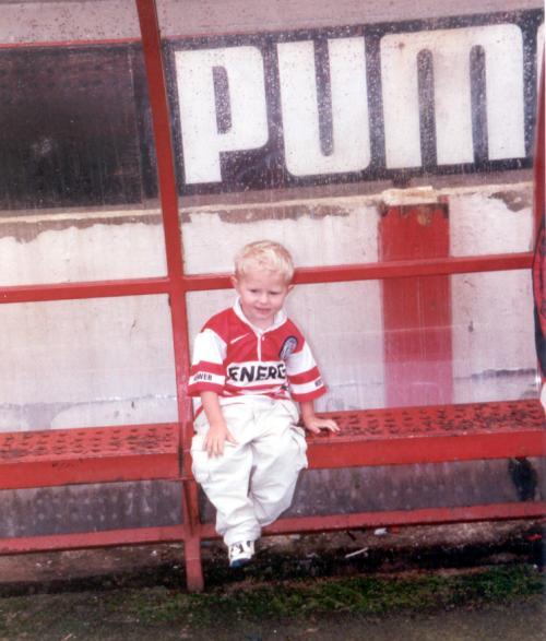 Young fan Lewiss in the dug-out.