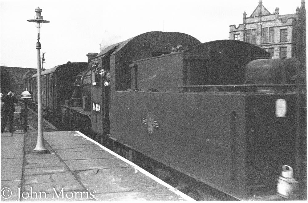 An Ivatt 2mt Mogul passing through Wallgate Station with a short goods train