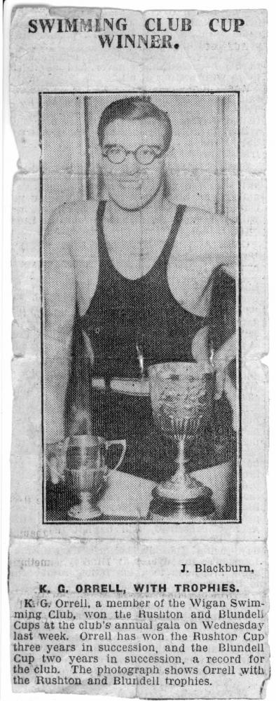 circa 1935 Ken Orrell with Wigan Swimming Club Rushton and Blundell swimming trophies.