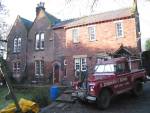 Fred's Land Rover and rear of house (85K)