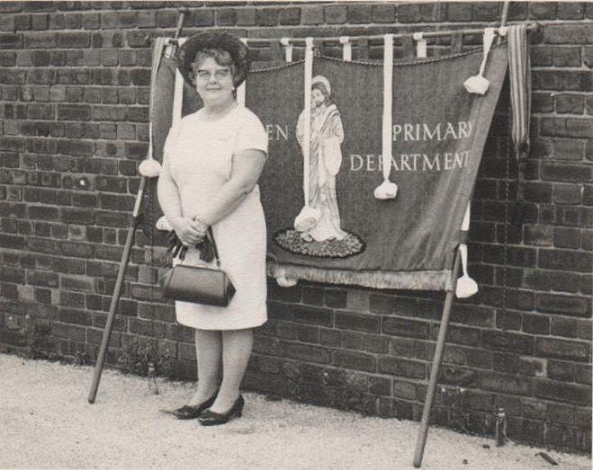 Hilda Green with Belle Green Banners in the school yard.