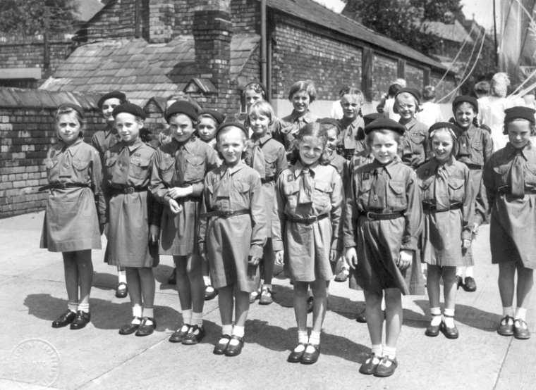 Brownies assemble in school yard, c1950.