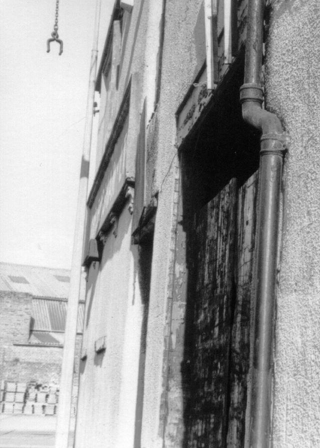 The view outside with the hook they used to lift the bales of woolens to the top floor, c1984.