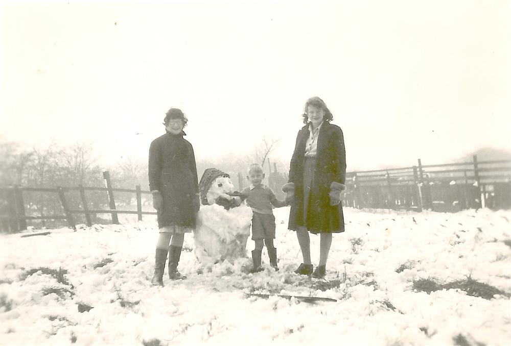 Winter snow February 1947-Building a snowman on the back Garden.