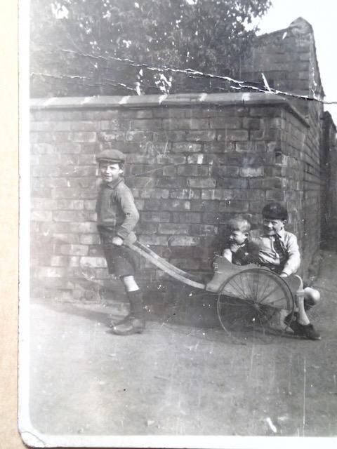 Kids with clogs and a barrow