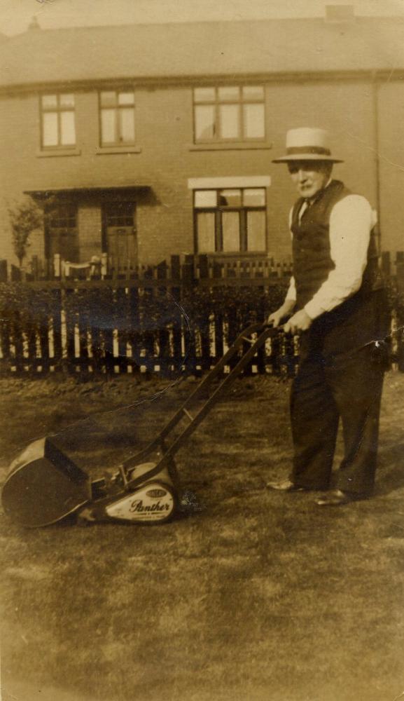 Matthew Matthews of Lower Ince, mowing his lawn.