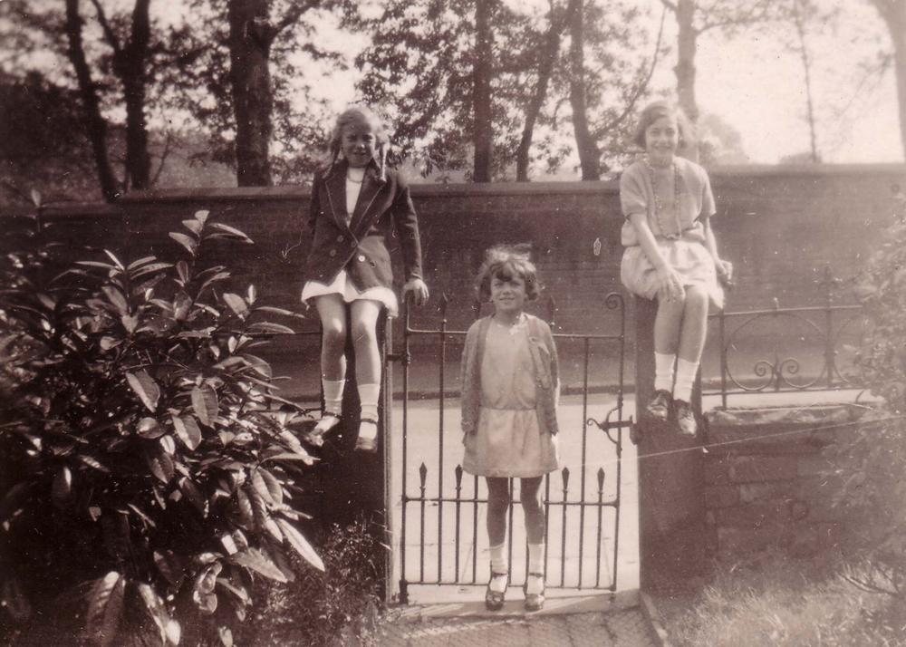 Three girls on a gate